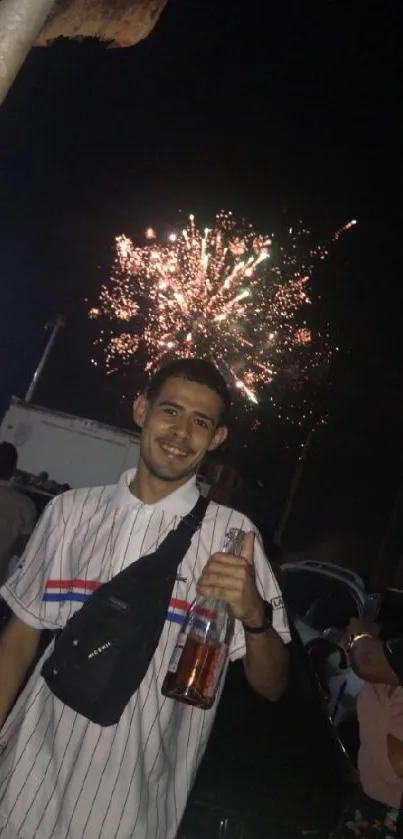 Man enjoying fireworks at night festival with a crowd.