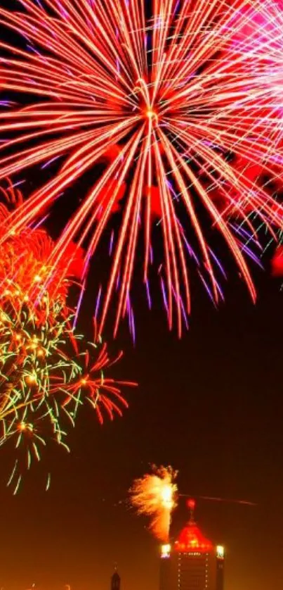 Vibrant fireworks illuminating the night sky over a cityscape.