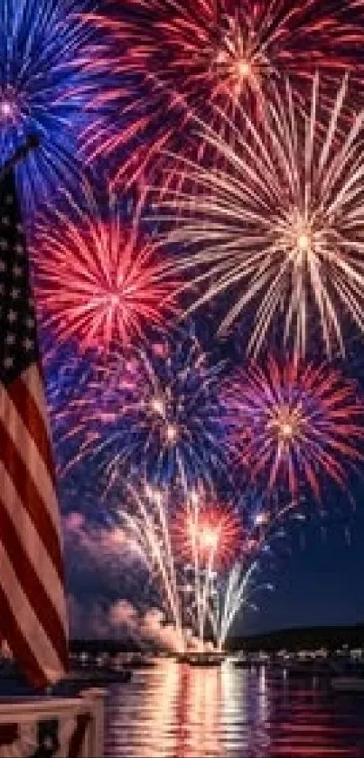 Colorful fireworks burst over a lake with an American flag.