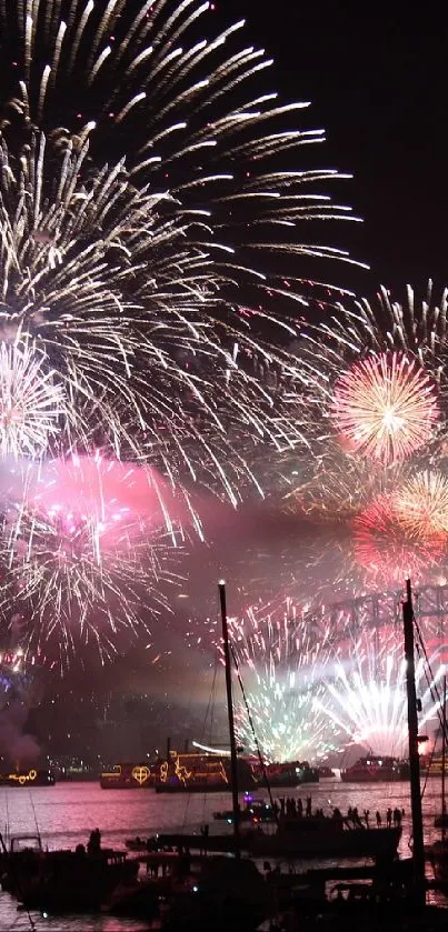 Vibrant fireworks over a tranquil waterfront at night.