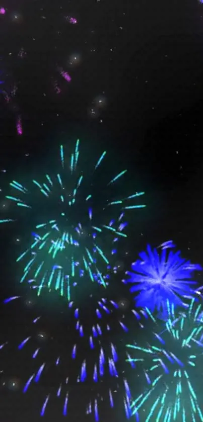 Vibrant fireworks in the night sky with blue and green glowing colors.