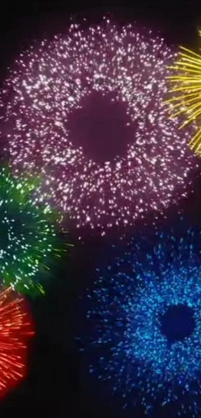 Vibrant fireworks display in various colors on dark background.