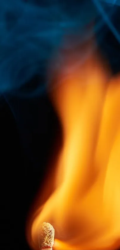 Vibrant flame with smoke on black background.