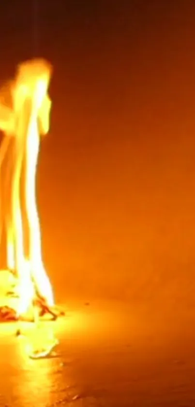 Mobile wallpaper showing a vibrant orange flame glowing brightly.