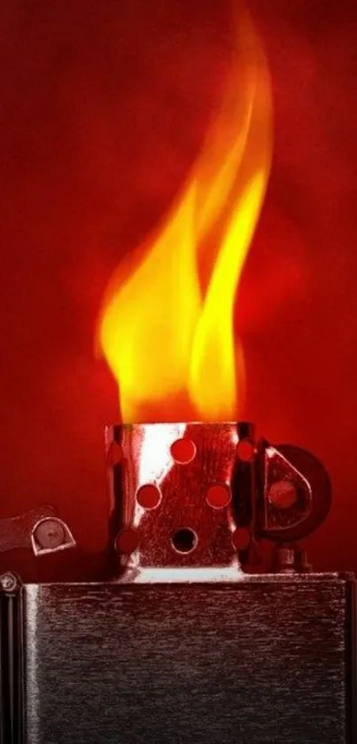 A vibrant flame from a metal lighter on a red background.