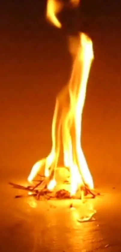 Orange flame with a glowing fire effect on a dark, warm background.