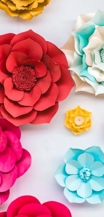 Vibrant colored paper flowers in red, blue, and yellow on a phone wallpaper.