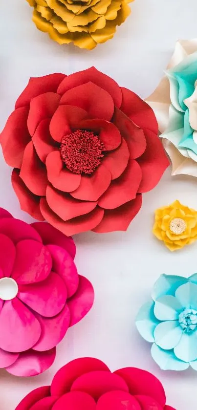 Colorful paper flowers on white background.