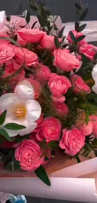 Vibrant bouquet of pink roses and white lilies.