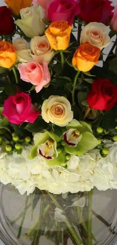 Vibrant floral bouquet with roses and orchids in a glass vase.