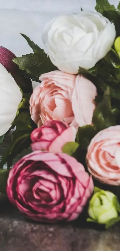 Vibrant bouquet of colorful roses with lush green leaves.