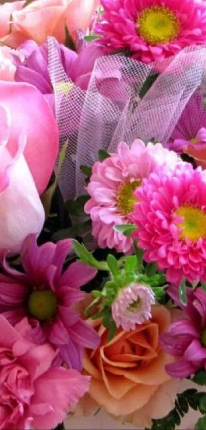 Pink and vibrant floral bouquet with roses and daisies.