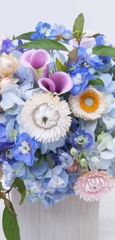 Vibrant bouquet of blue and pink flowers in vase.