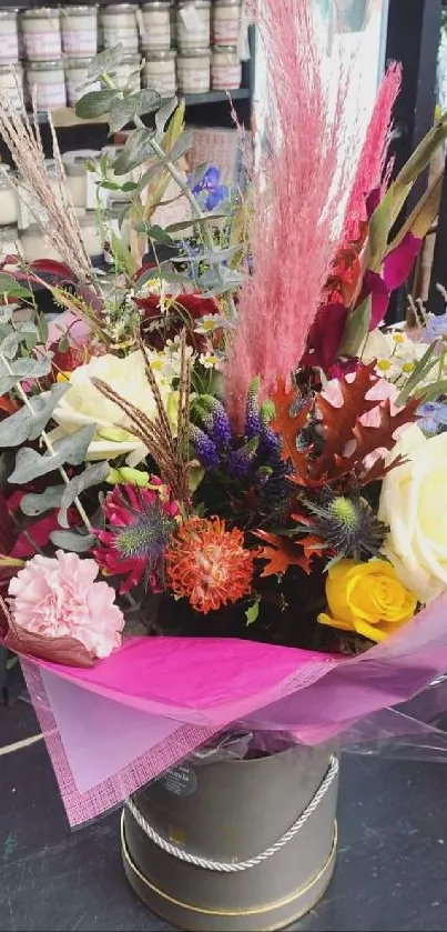 Vibrant bouquet with colorful flowers and pink wrappings.