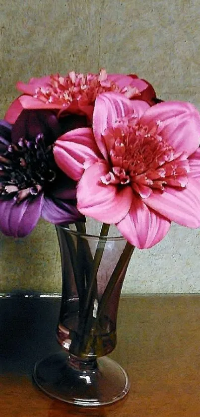 Pink and purple flower bouquet in a vase on a wooden surface.