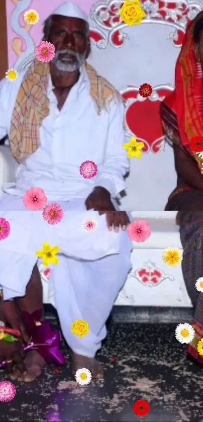 Elderly couple in traditional attire, adorned with colorful flowers.