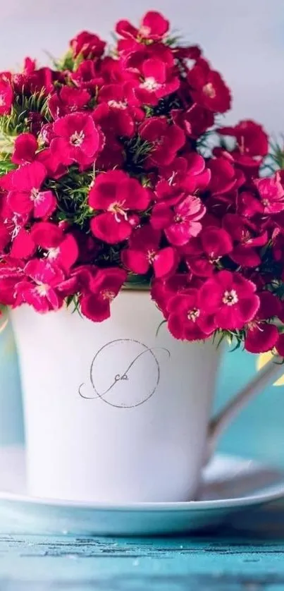 White cup with red flowers on blue background.