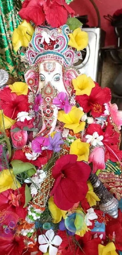 Floral adorned deity with vibrant red and yellow petals.