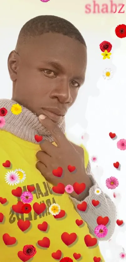 Man in yellow hoodie surrounded by flowers and hearts.