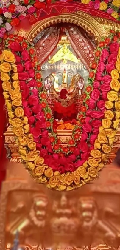 Sacred idol adorned with colorful floral garlands and vibrant decorations.