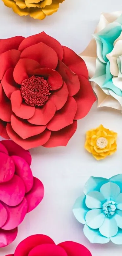 Vibrant paper flower art wallpaper in red, blue, and yellow hues.