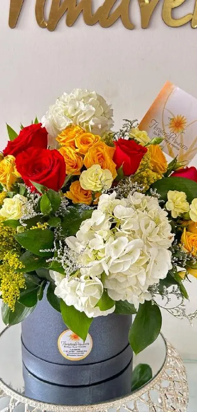 Vibrant floral bouquet with red, yellow, and white blooms in a decorative vase.