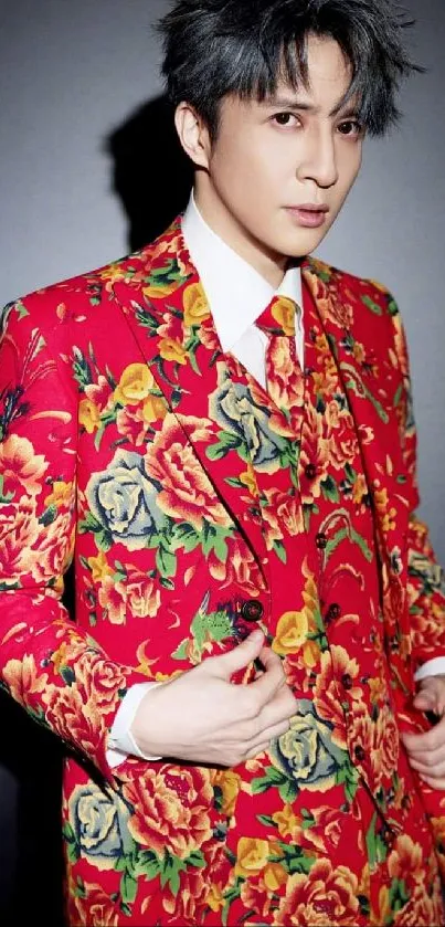 Man in a vibrant floral red suit with a rose pattern.