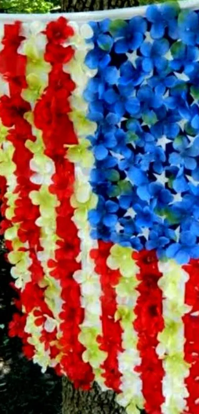 Floral USA flag design with vibrant red, white, and blue flowers hanging on a tree.