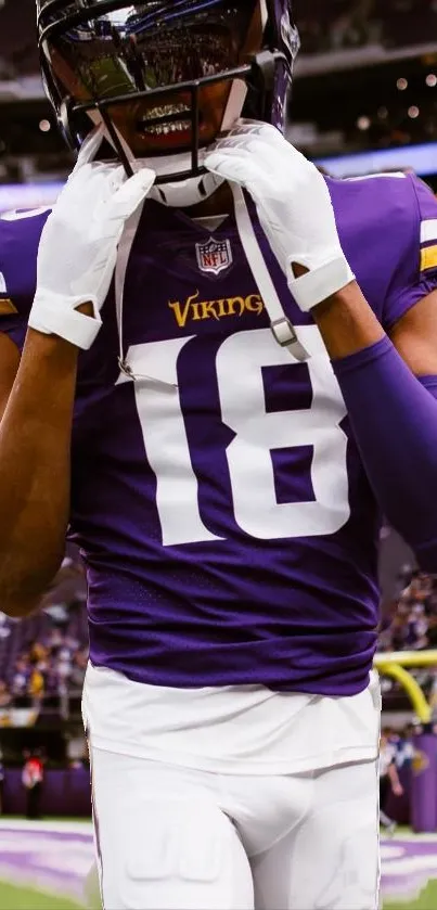 Football player in purple attire focusing passionately on the game field.