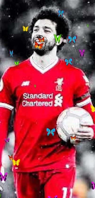 Lively footballer in vibrant red gear on a dynamic wallpaper scene.