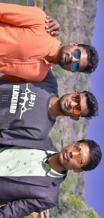 Group of friends posing outdoors in vibrant attire against a natural backdrop.