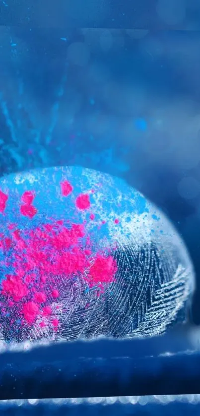 Artistic ice sphere with blue and pink colors on a frosty background.