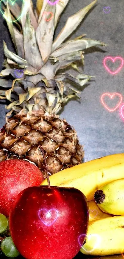 A vibrant fruit arrangement with bananas, apples, grapes, and a pineapple on a gray background.