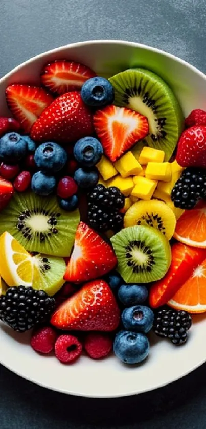 Colorful fruit bowl wallpaper with strawberries, kiwis, and citrus slices.