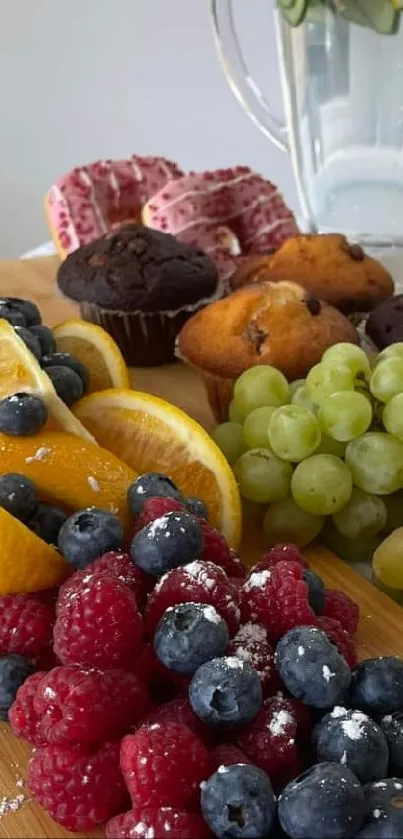 Colorful fruit platter with grapes, berries, and oranges on a wooden board.