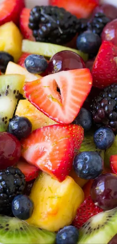 Colorful fruit salad with strawberries, kiwi, and grapes.