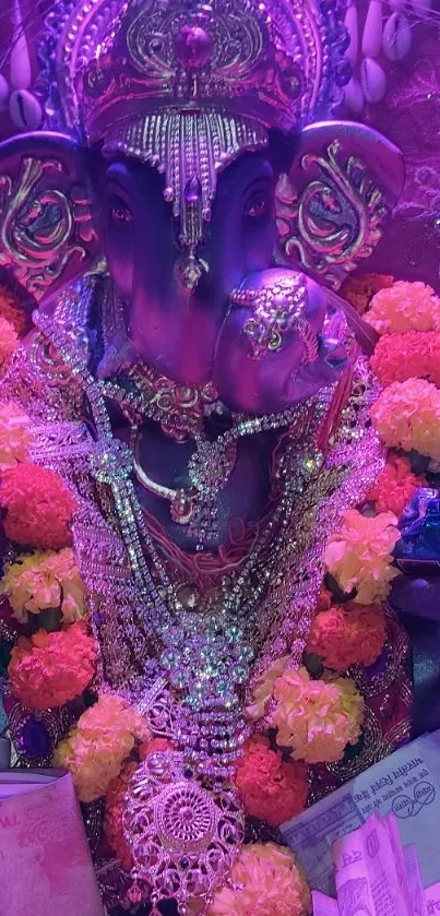 Intricately decorated Ganesh idol with colorful flowers and jewels.