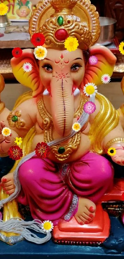 Colorful Ganesh idol with vivid pink attire on display.