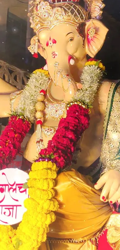 Vibrant Ganesha idol adorned with floral garlands at a festival.