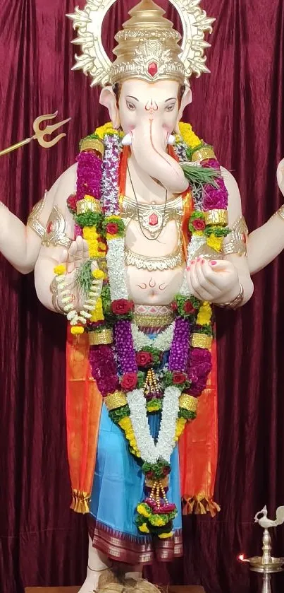 Lord Ganesha adorned with colorful garlands in a vibrant display.