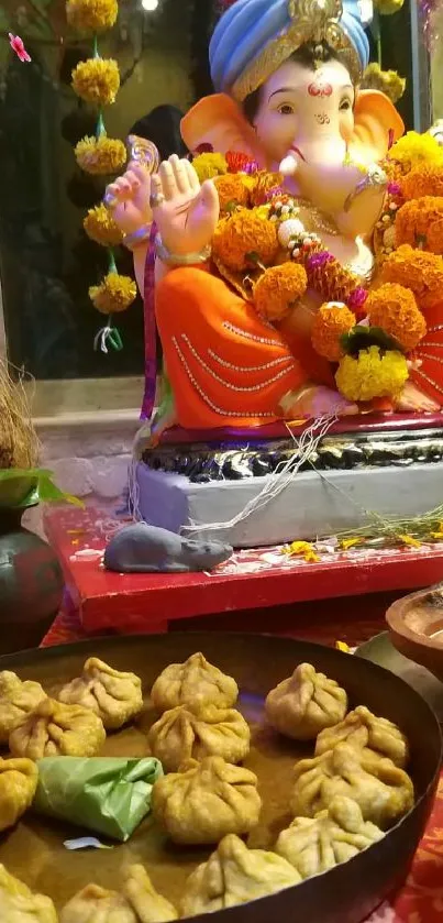 Colorful Ganesha idol with festive decorations and sweets.