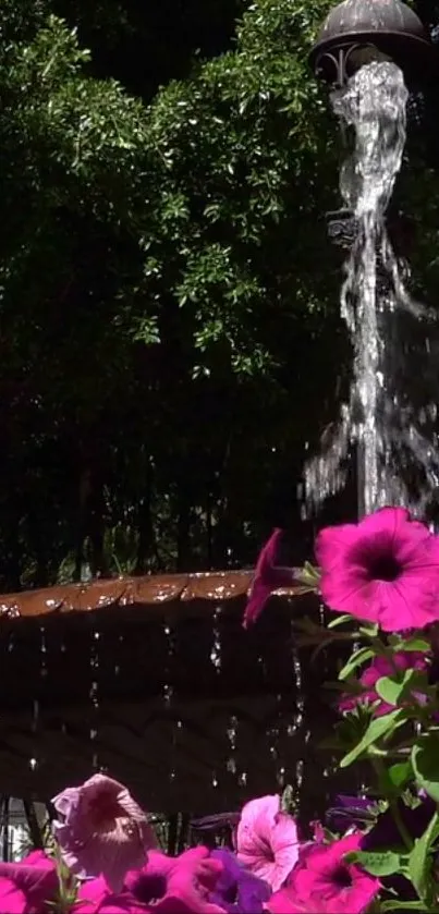 Vibrant garden fountain with pink flowers and flowing water.