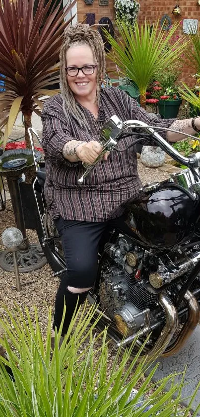 Biker sitting on a motorcycle surrounded by lush garden plants.