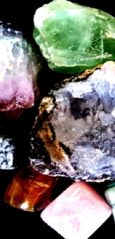 Collection of colorful gemstones on a black background wallpaper.
