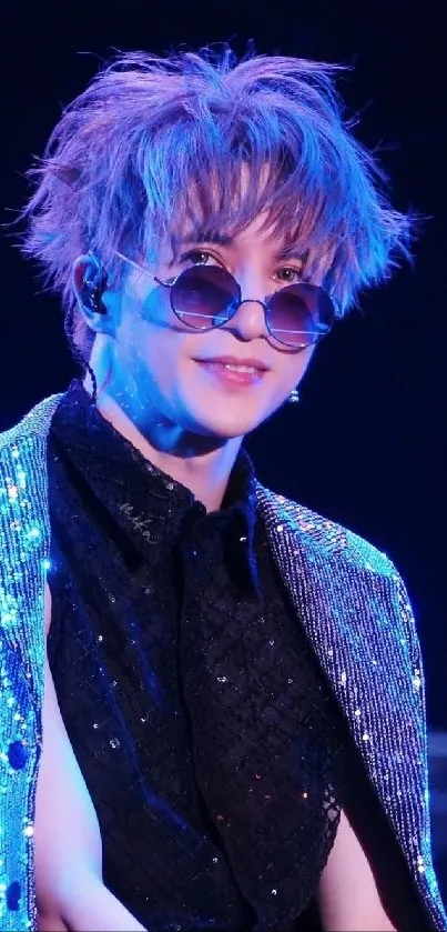 Glam rock star in sparkly blue jacket with sunglasses.