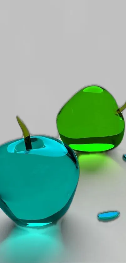 Vibrant glass apples in teal and green on a light grey background.