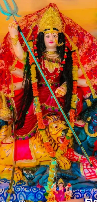 Vibrant depiction of Goddess Durga in traditional attire on a red background.