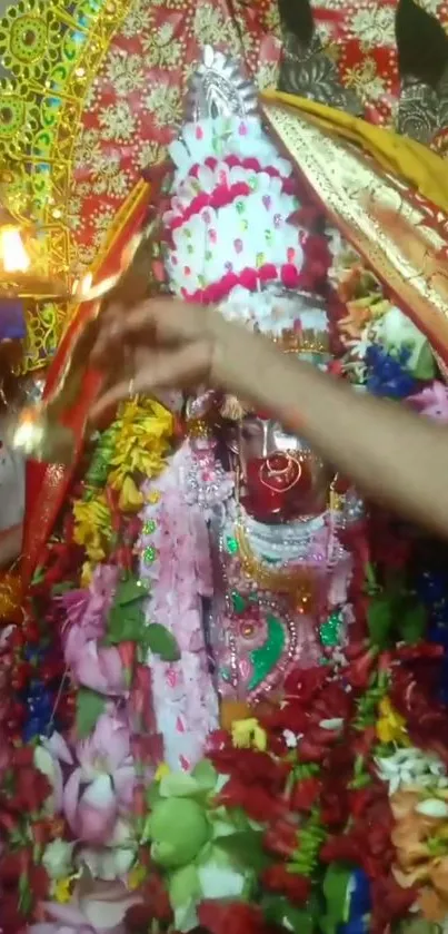 Colorful Hindu goddess idol adorned with flowers and decorations.