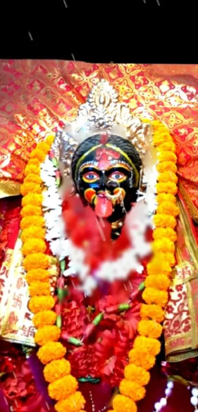 Goddess Kali adorned with vibrant garlands and a rich red backdrop.