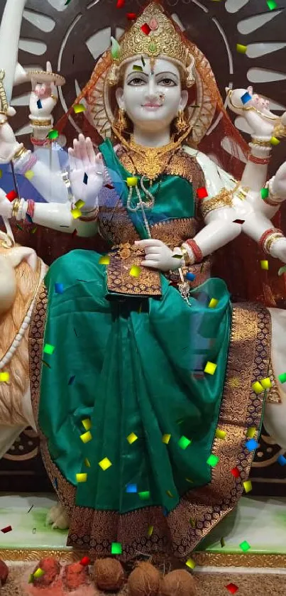 Colorful goddess statue with teal attire and festive confetti.